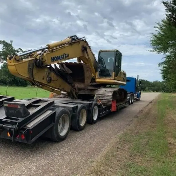 Excavator loaded on a lowboy trailer for transport to a job
