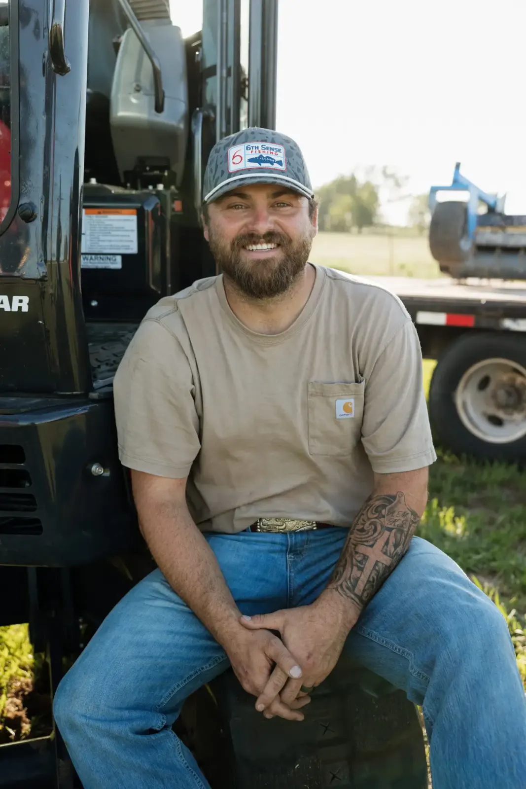 Payton Wilson, co-founder of 4W Land Management Services, seated by his equipment