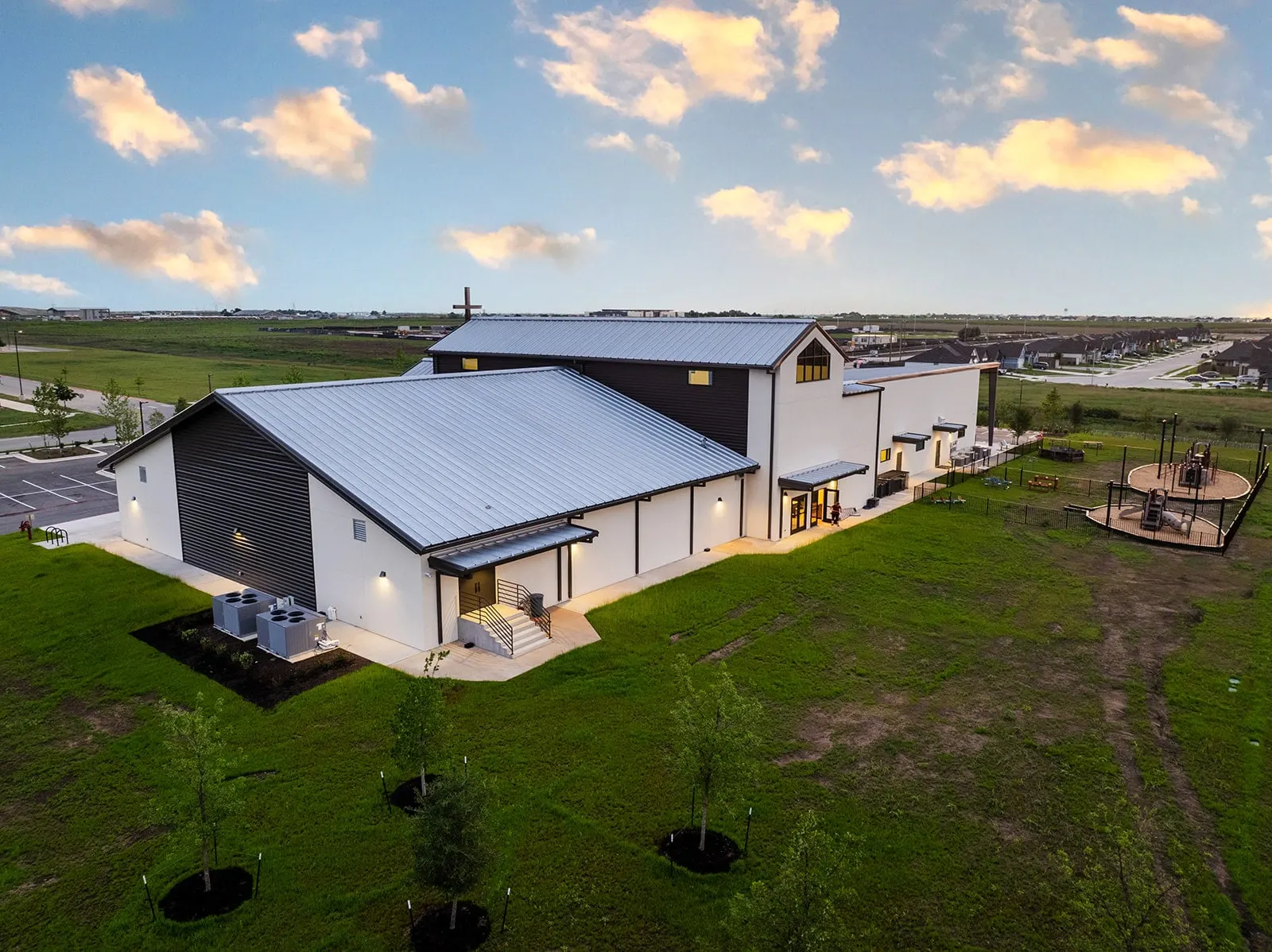Aerial view of a finished church campus at dusk