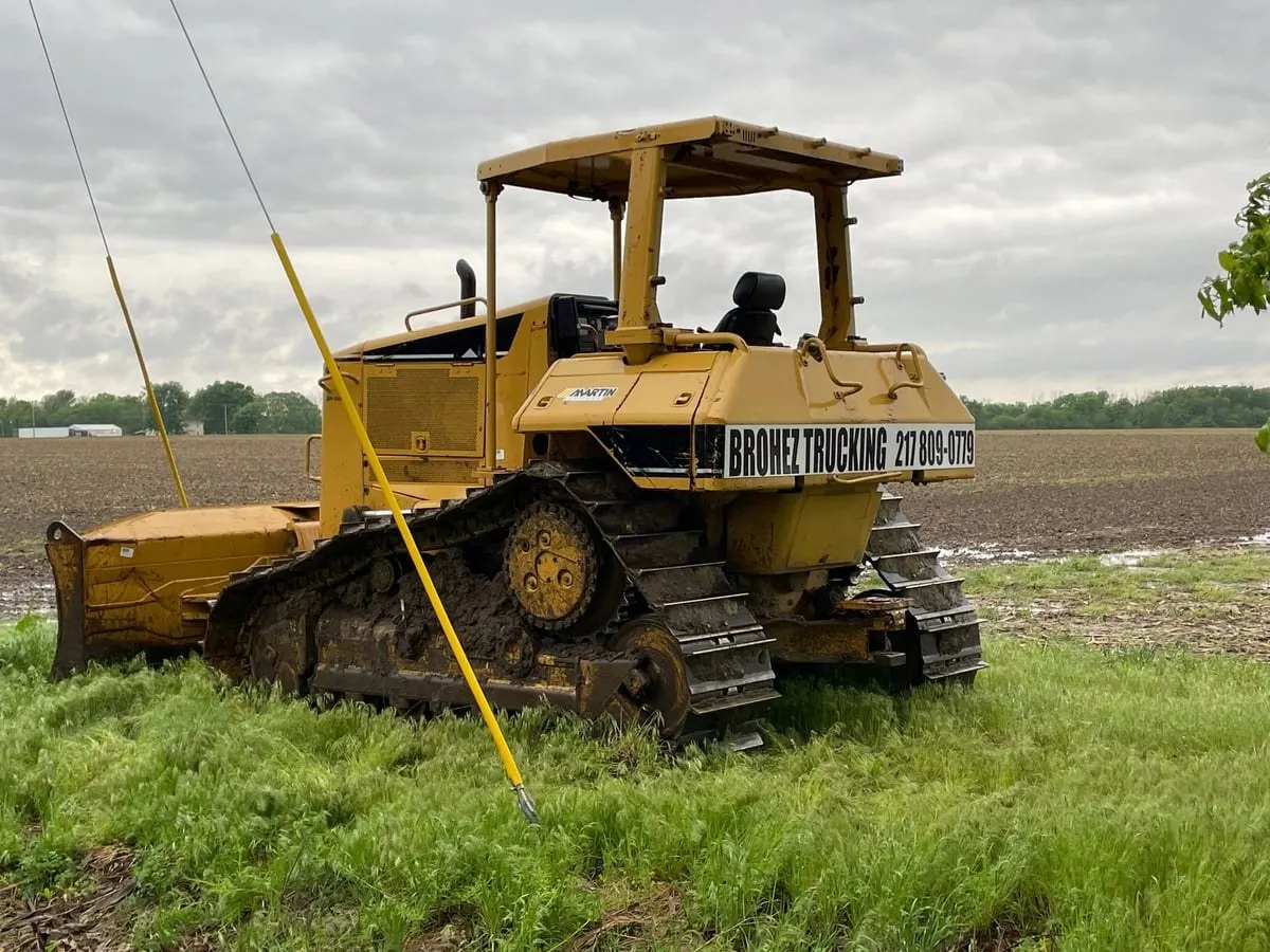Brohez Trucking Cat D6N dozer parked at the edge of a farm field