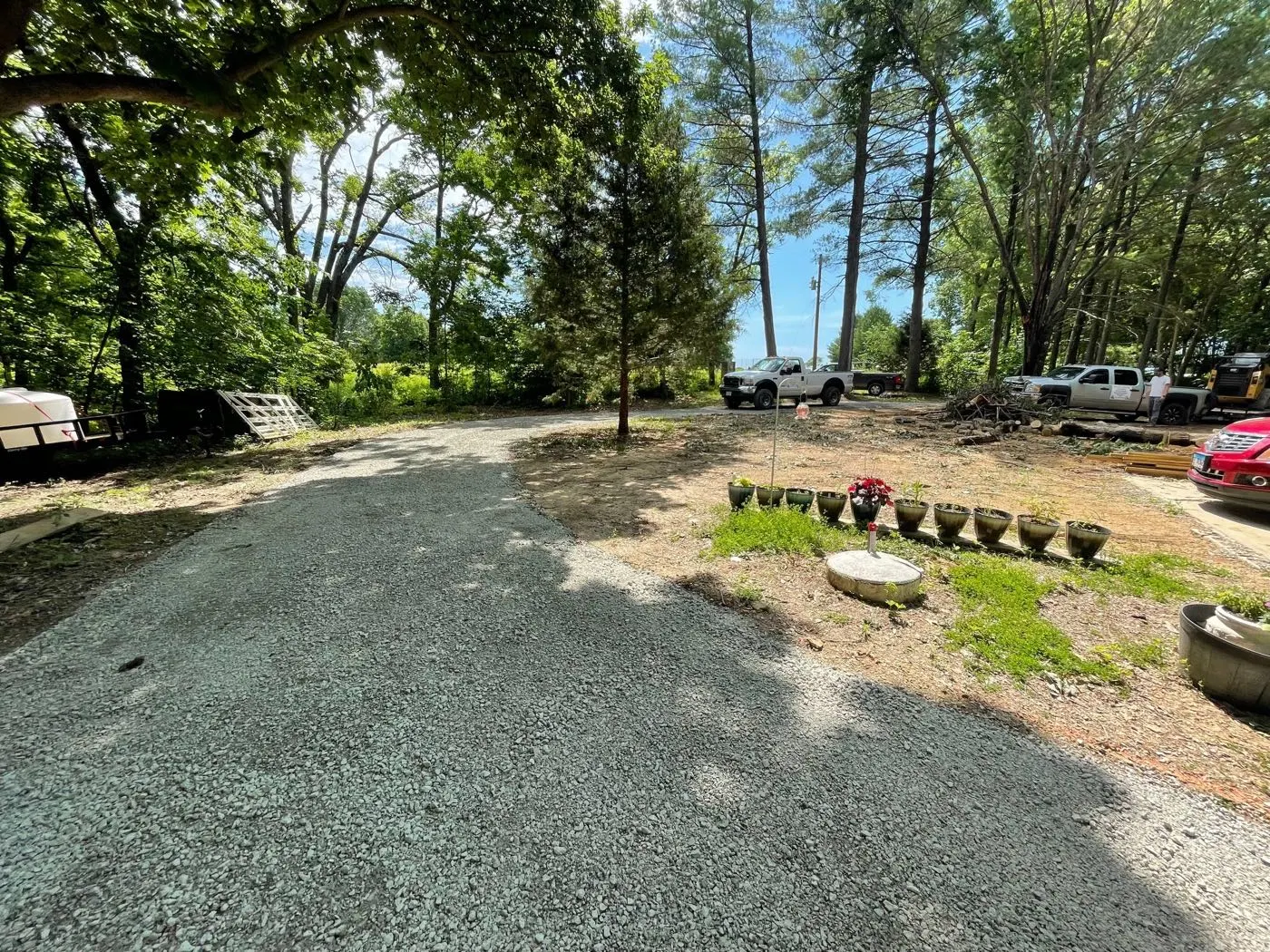 Finished crushed-stone driveway lined with trees in central Illinois