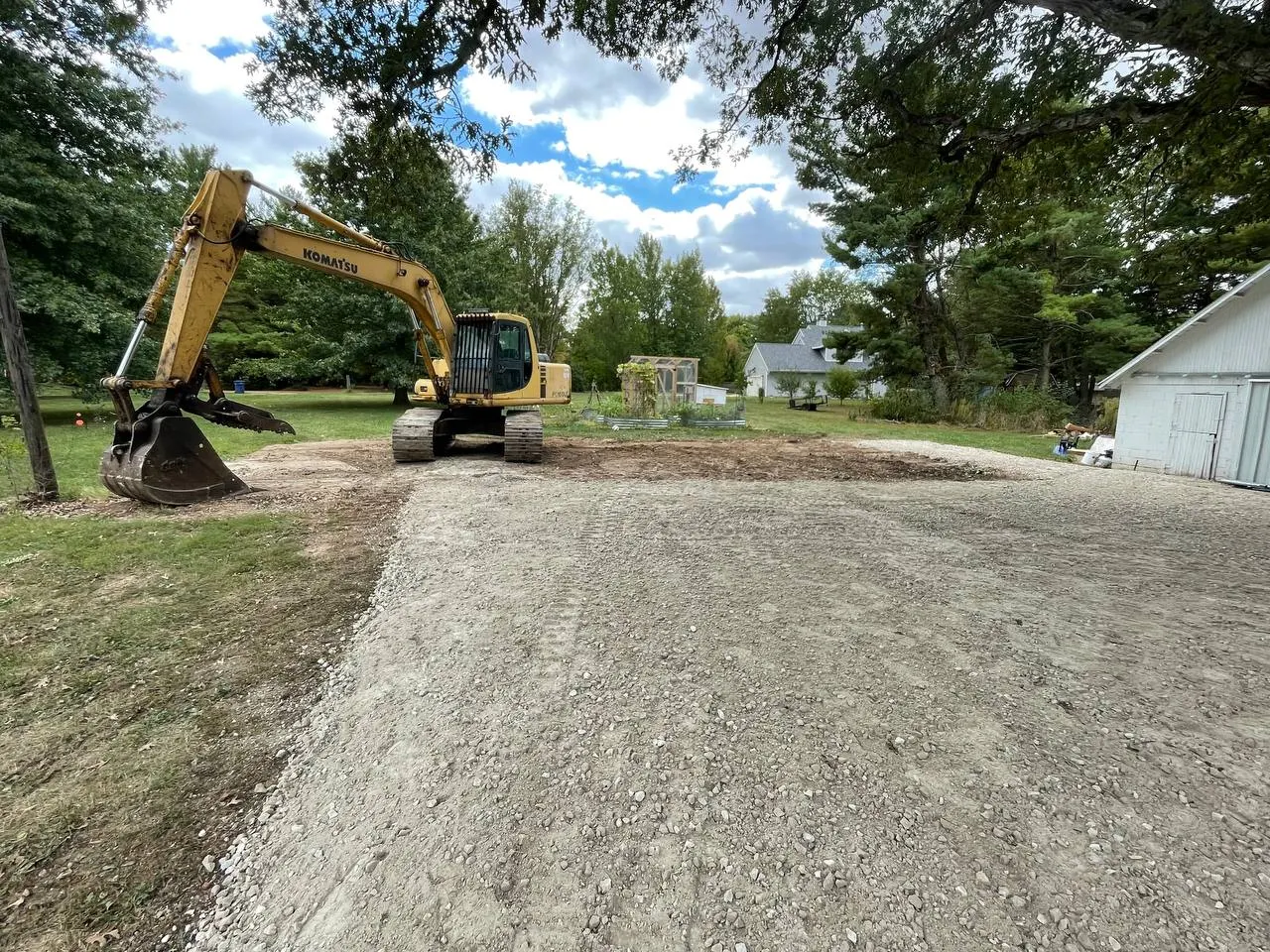 Komatsu excavator next to a freshly rocked building pad in central Illinois