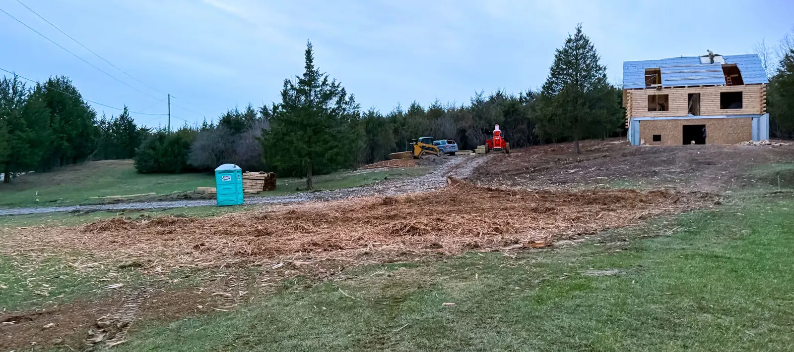 Cleared and graded lot beside a new house under construction
