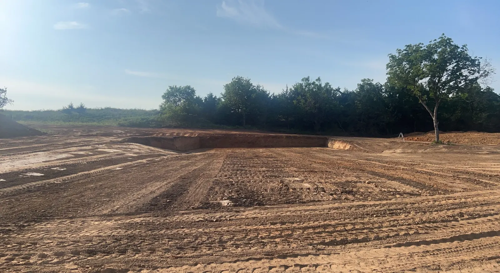 Large graded site with cut slopes and a tree line