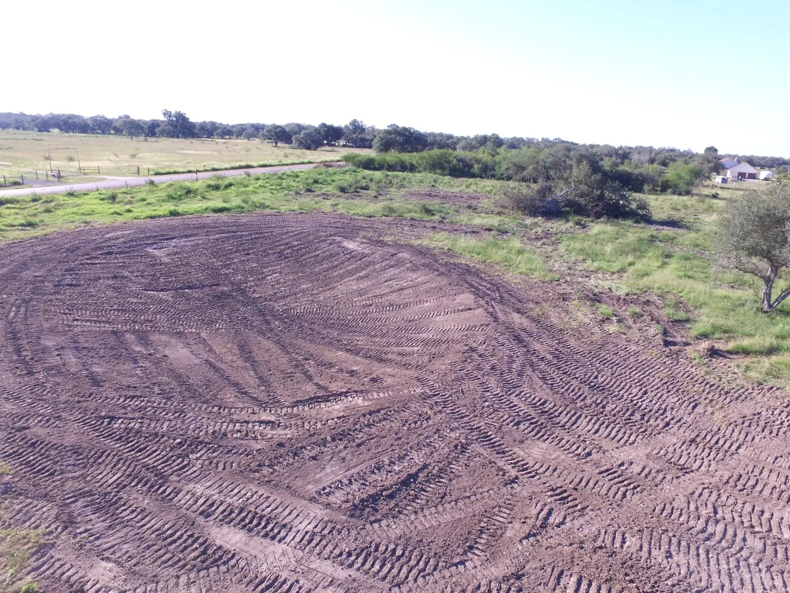 Aerial view of a freshly graded pad cut into pasture near Goliad, TX