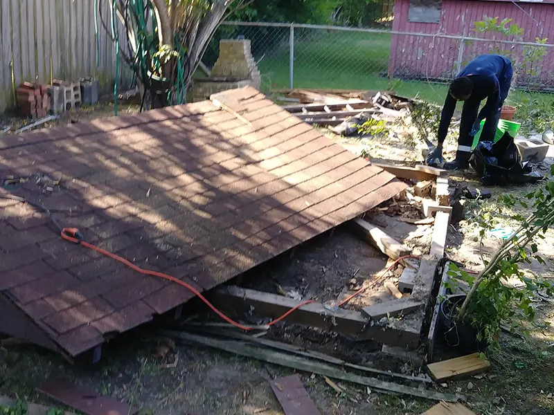 Right On Time crew tearing down a backyard shed in Houston