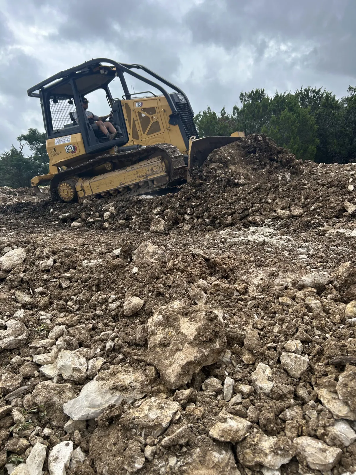 Dozer pushing rocky soil on a Central Texas property