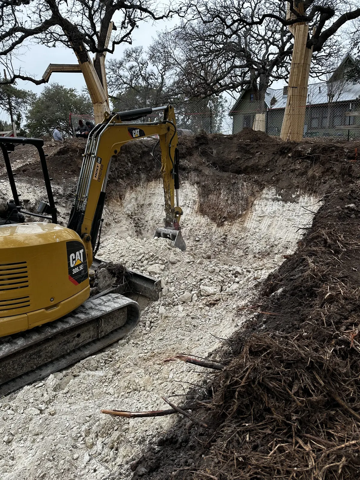 Mini excavator digging out a residential site in Central Texas